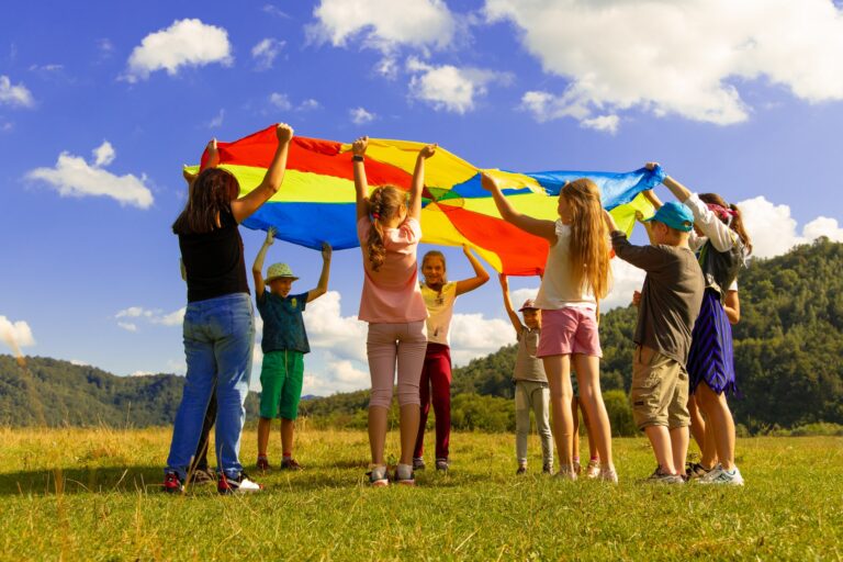 Pupils holding colourful parachute